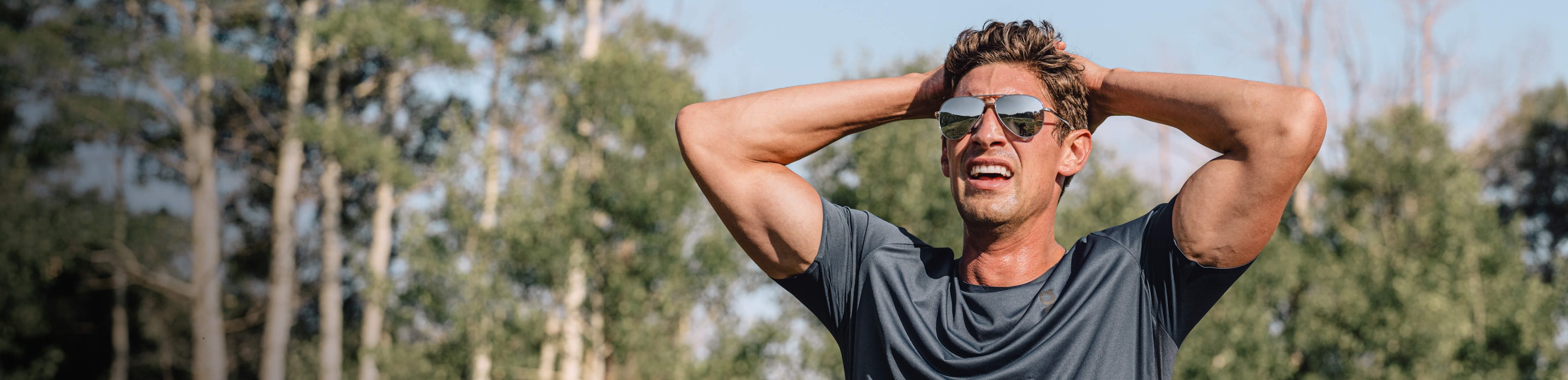 Man post run wearing ROKa sunglasses in woods