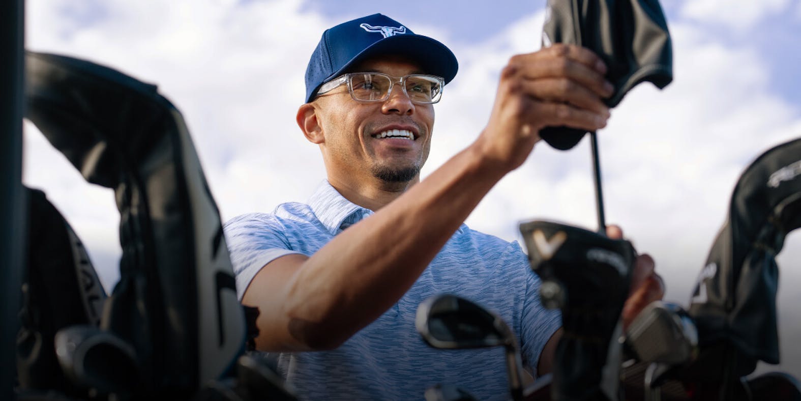 Man grabbing golf club from bag