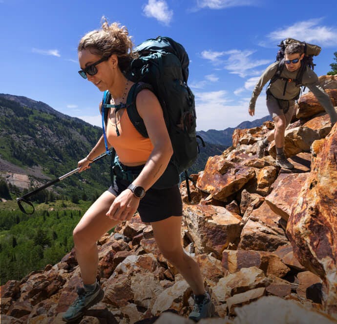 Man and woman hiking wearing ROKA sunglasses