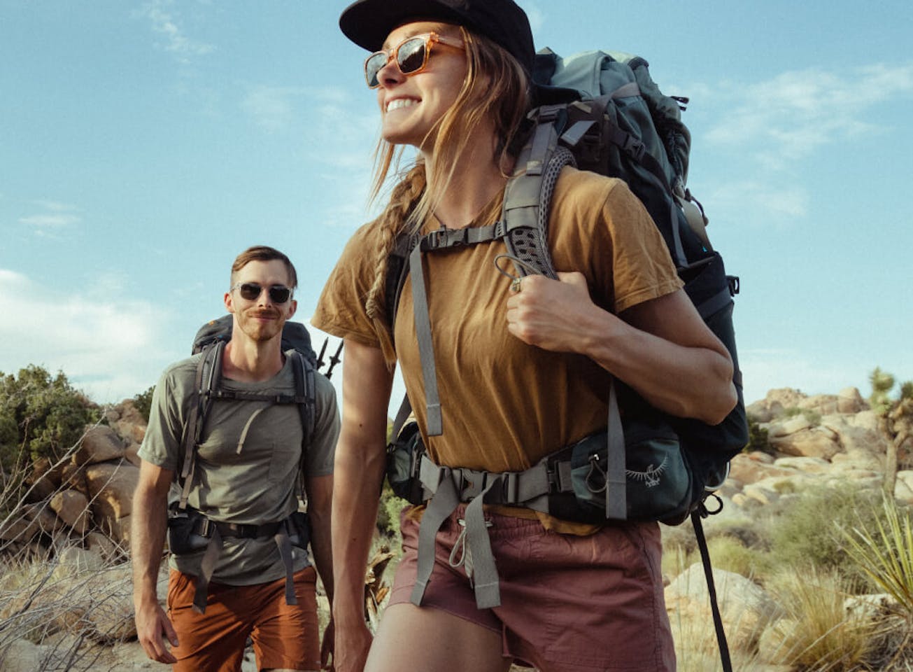 Man and woman backpacking wearing ROKA sunglasses