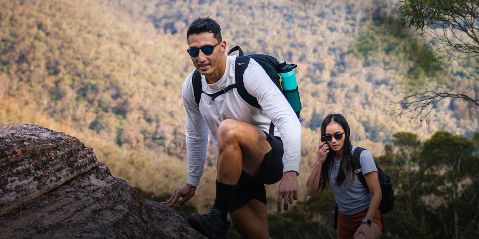 Man and woman backpacking wearing ROKA sunglasses