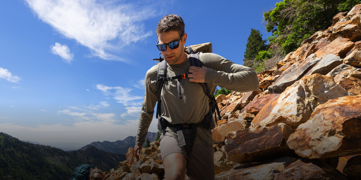 Man backpacking wearing ROKA sunglasses