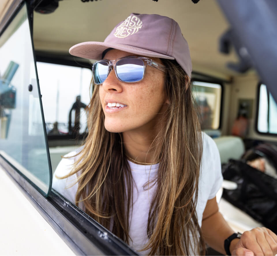 Woman wearing pink hat and ROKA mirrored sunglasses