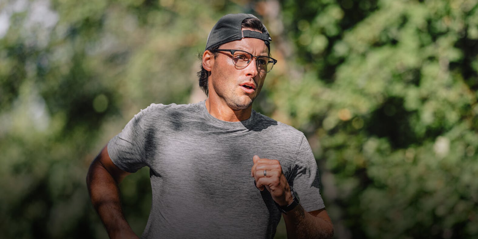Man running in woods in ROKA eyeglasses