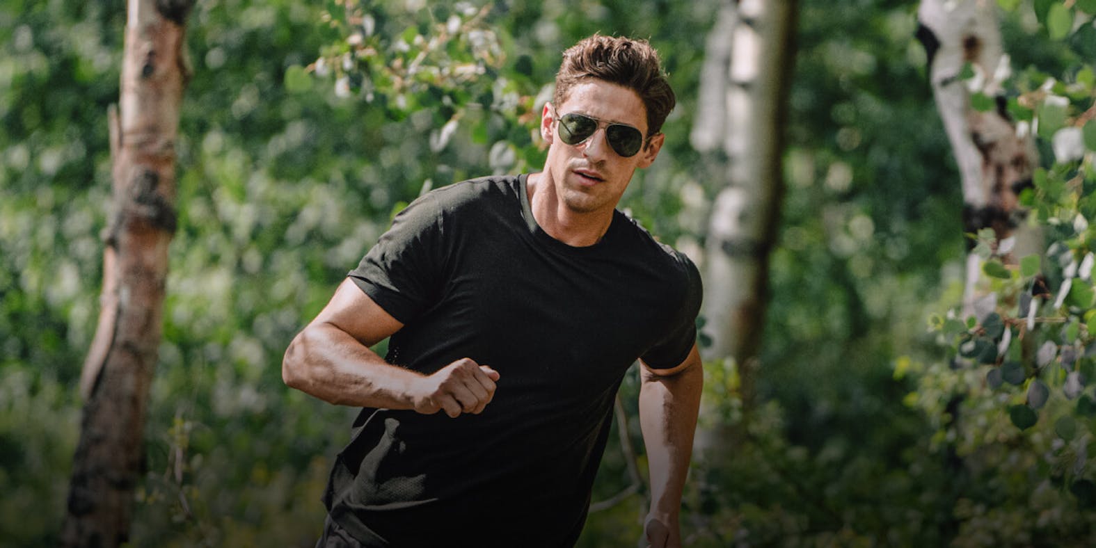 Man running in woods in ROKA sunglasses