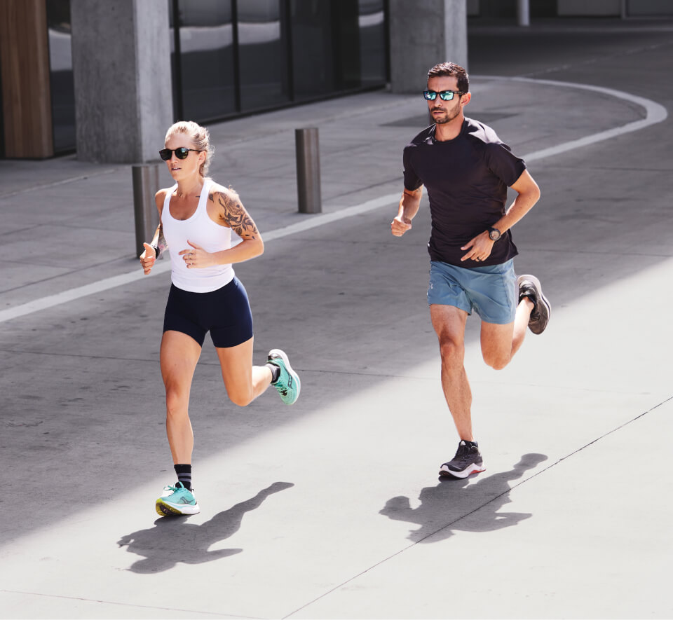 Man and woman jogging in street