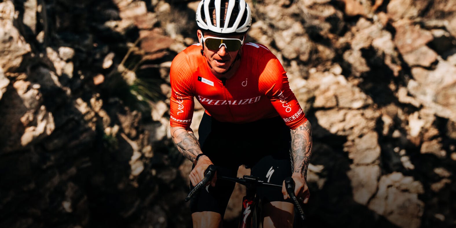 Man wearing orange tri top and ROKa sunglasses