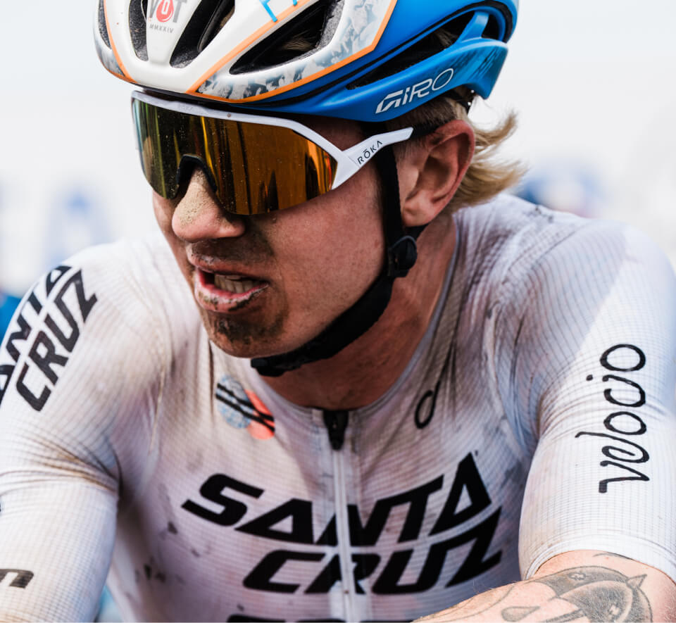 Man with dirt on face and cycling gear