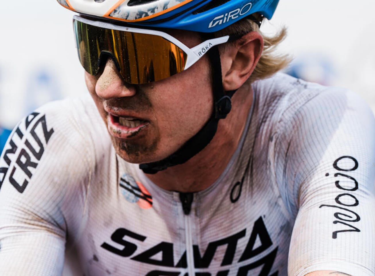 Man with dirt on face and cycling gear