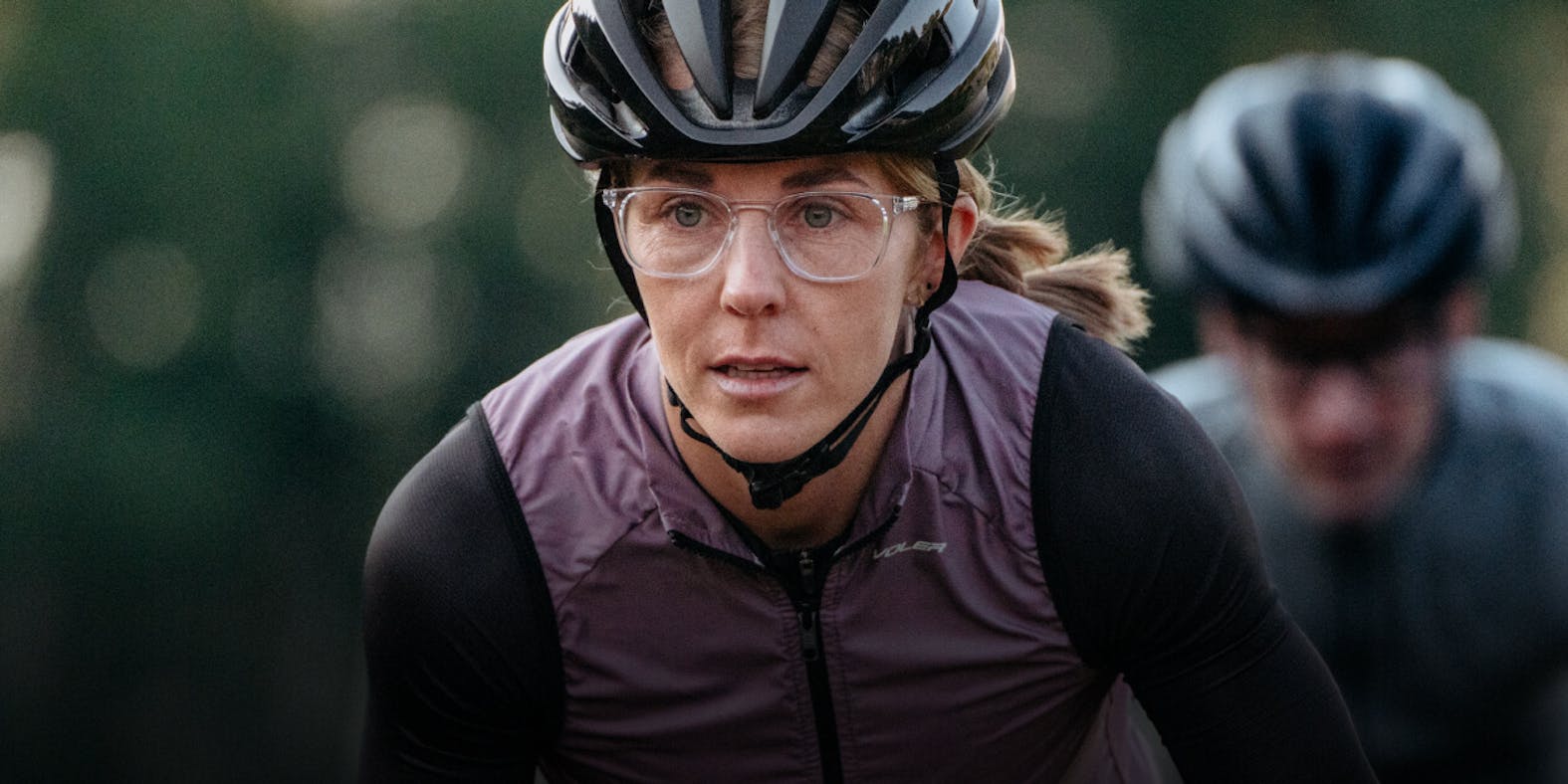 Woman wearing cycling helmet and ROKA eyeglasses