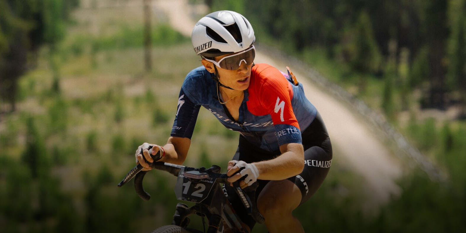 Woman cycling on dirt road