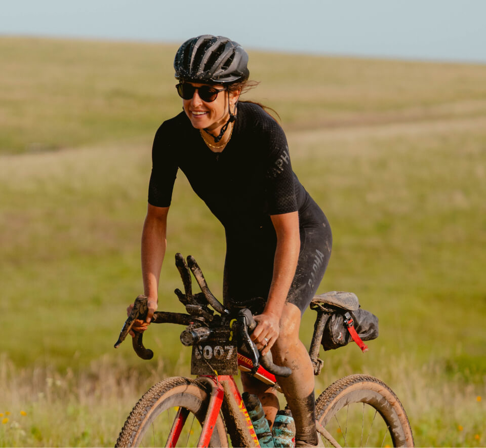 Woman cycling through plain