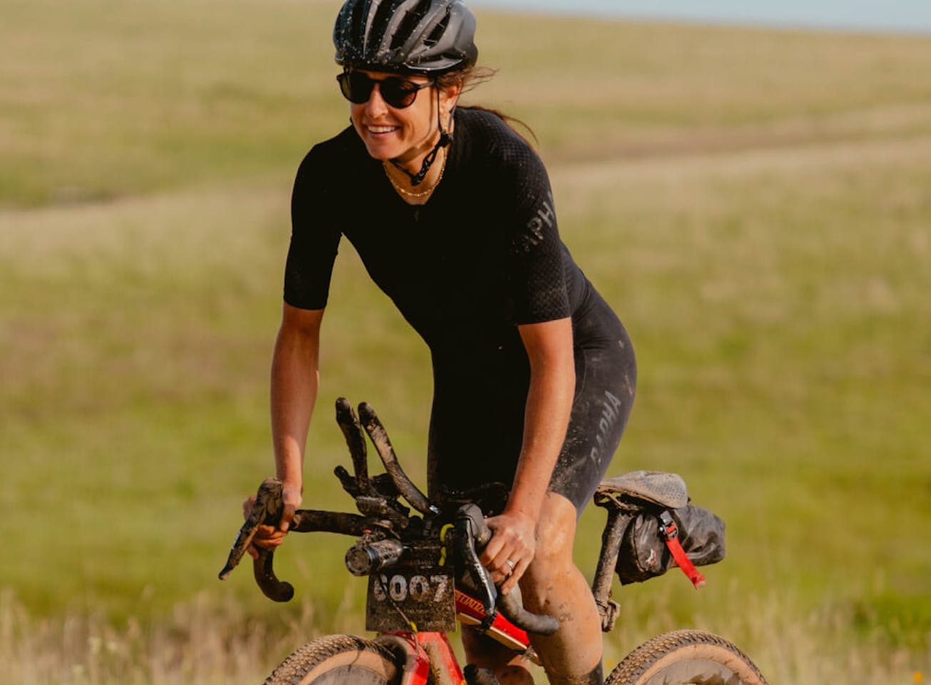 Woman cycling through plain