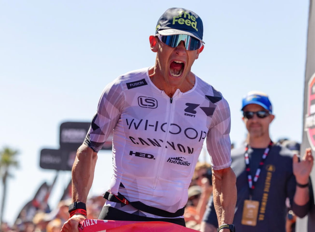 Man crossing finish line at triathlon
