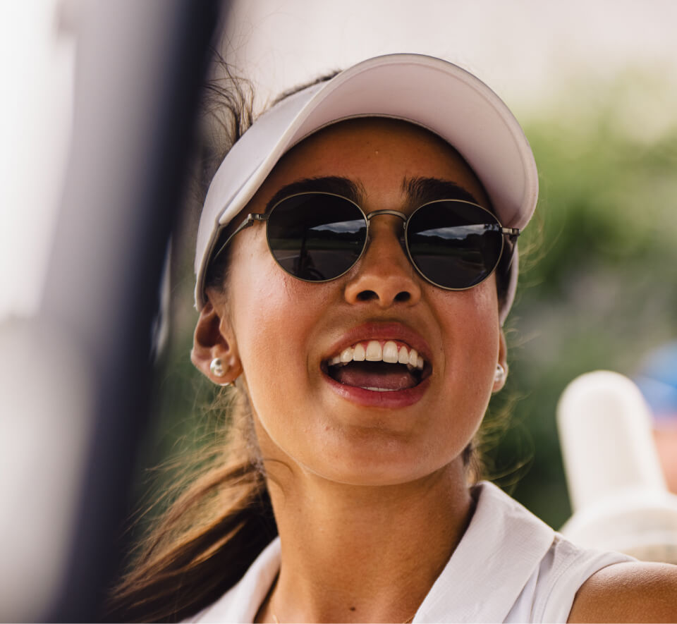 Woman wearing white golf hat and Alto Sunglasses
