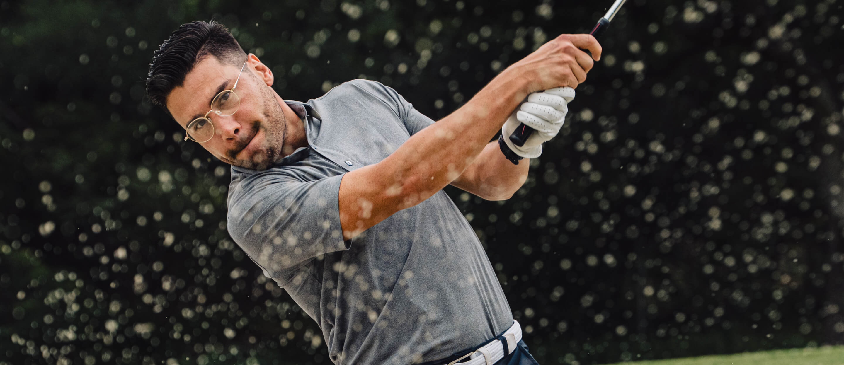 Man swinging golf club in Alto Eyeglasses