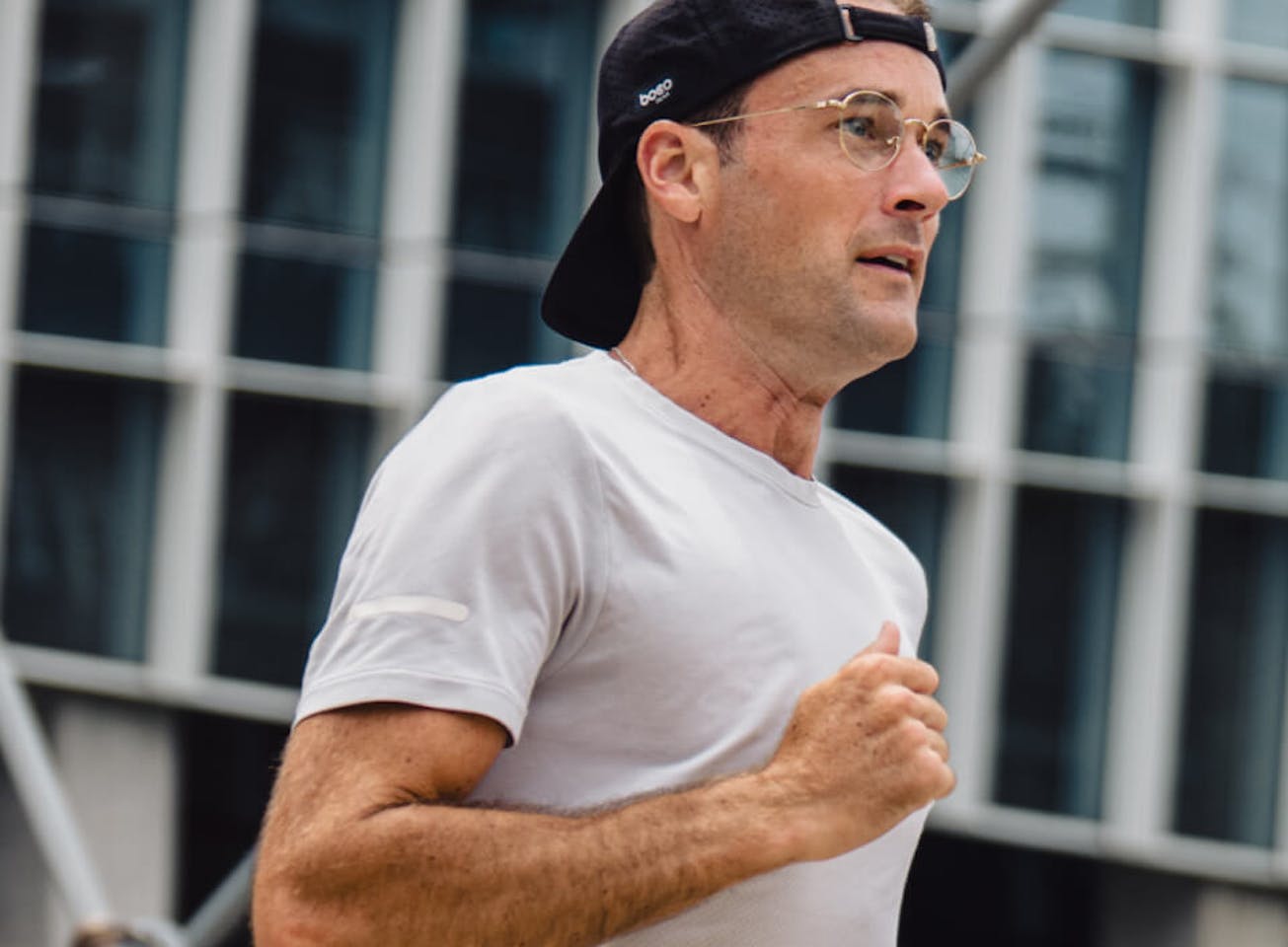 Man jogging in black hat and Alto Eyeglasses