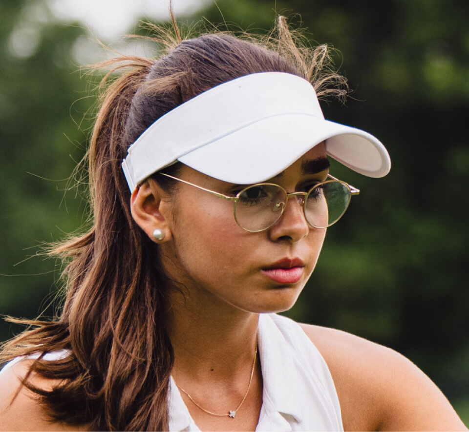 Woman wearing white golf hat and Alto Eyeglasses