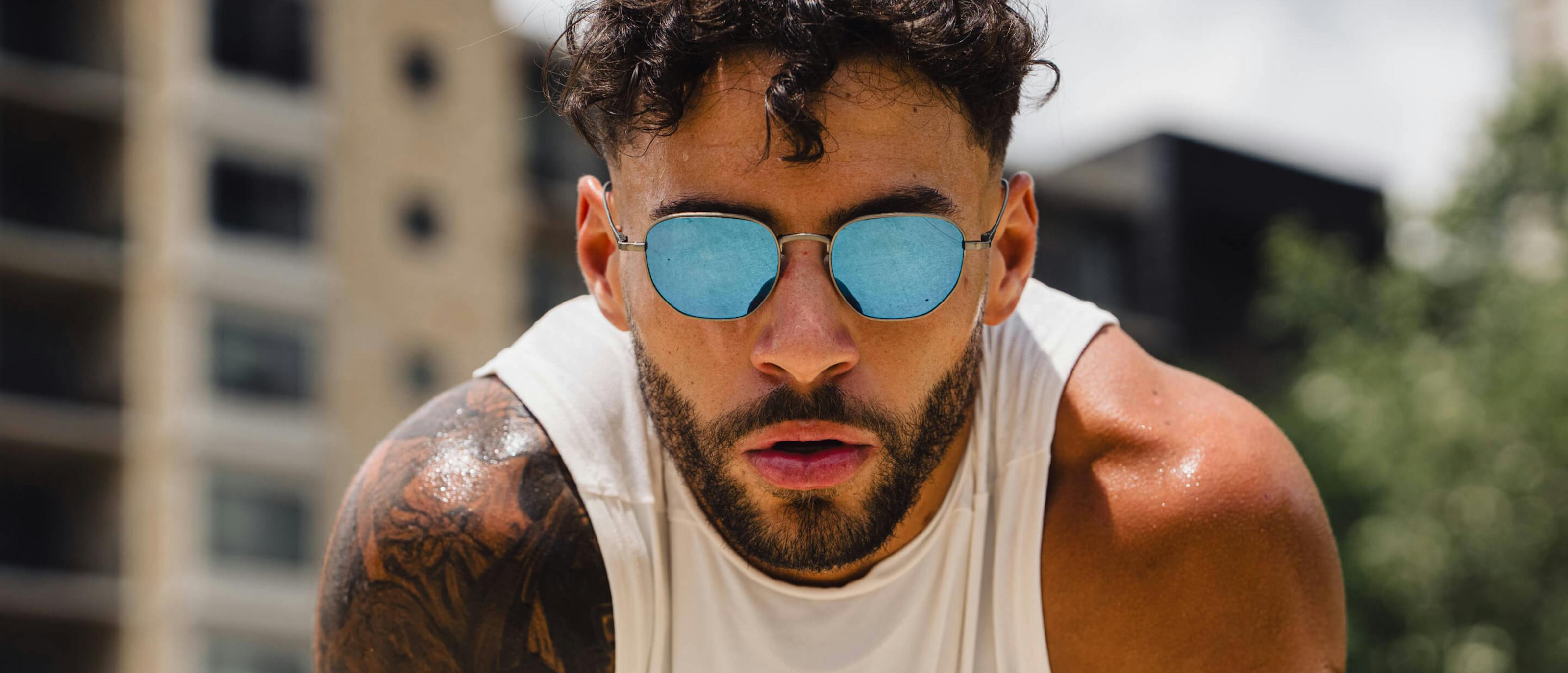 Man wearing white tank top and Lyno Sunglasses