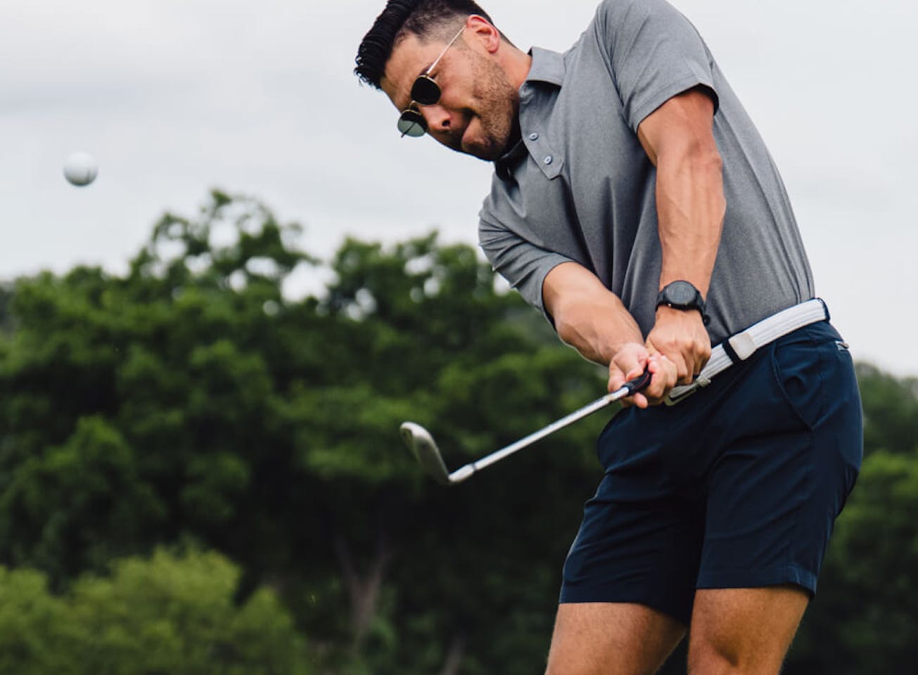 Man swinging golf club in Lyno Sunglasses