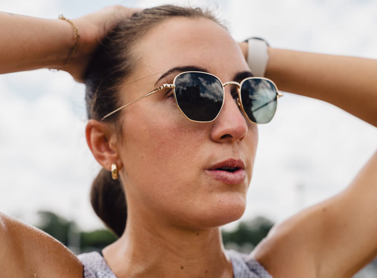 Woman with hands over head in Lyno Sunglasses