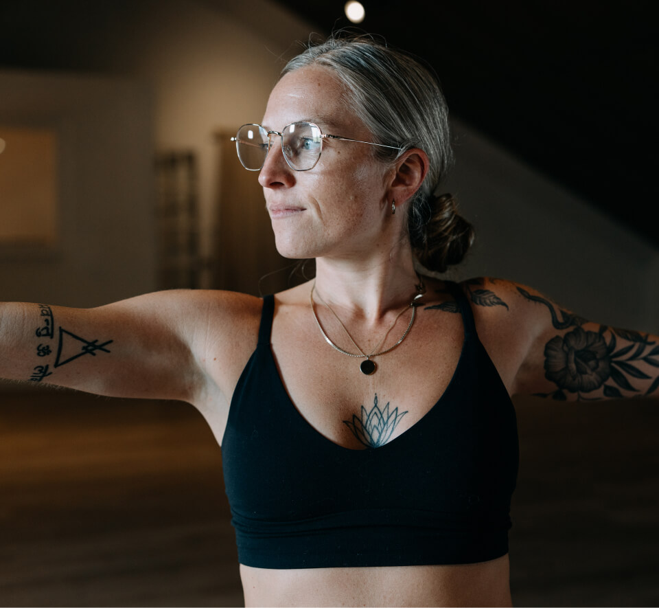 Woman doing yoga in black top in Lyno Eyeglasses