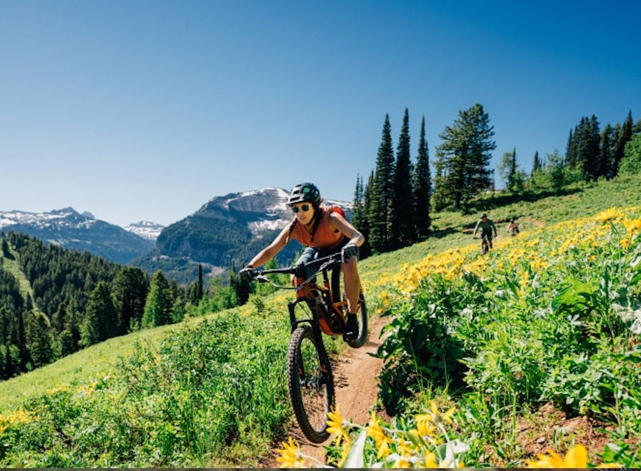Woman mountain biking wearing Lockhart sunglasses