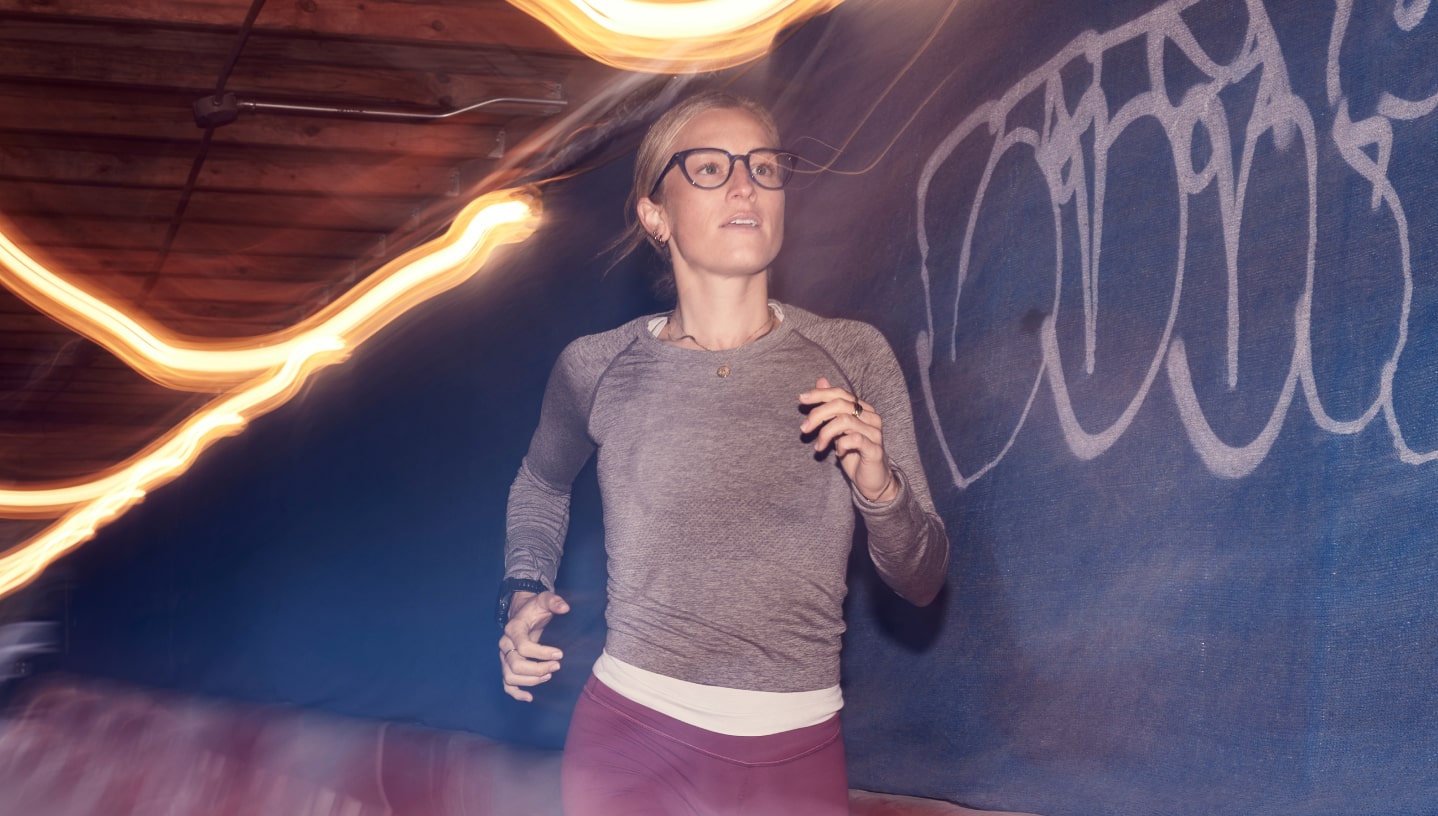 Woman running wearing cat eye shape, clear Lola eyeglasses