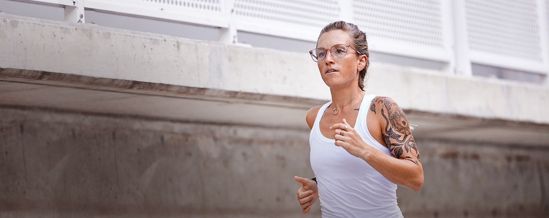 Woman jogging in white tank top