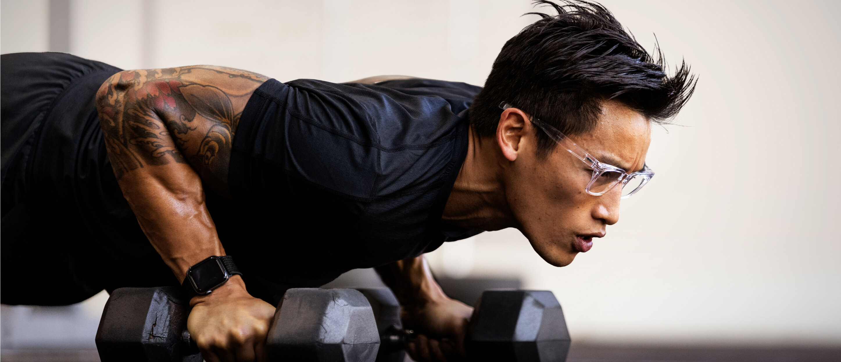 Man doing dumbell pushups in Lockhart eyeglasses