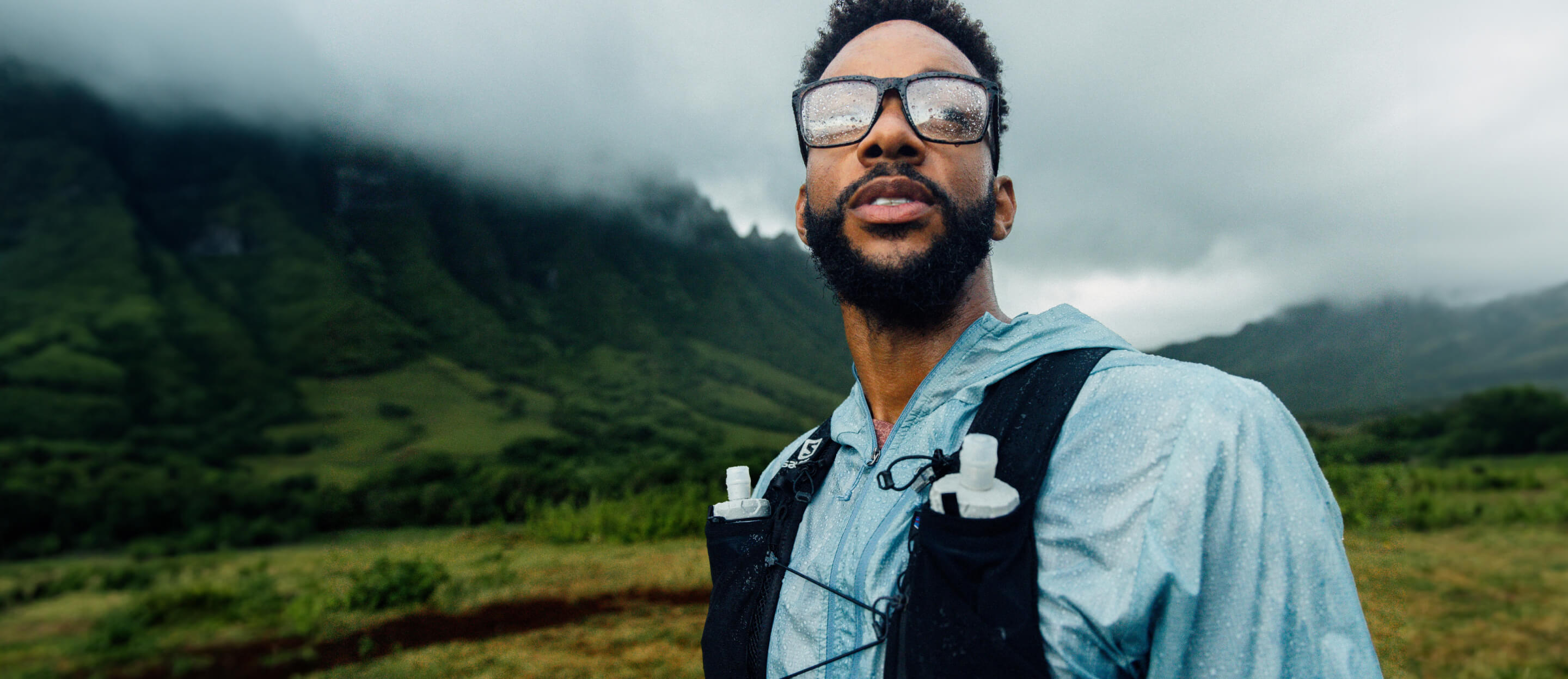Man outside, raining, wearing Barton eyeglasses
