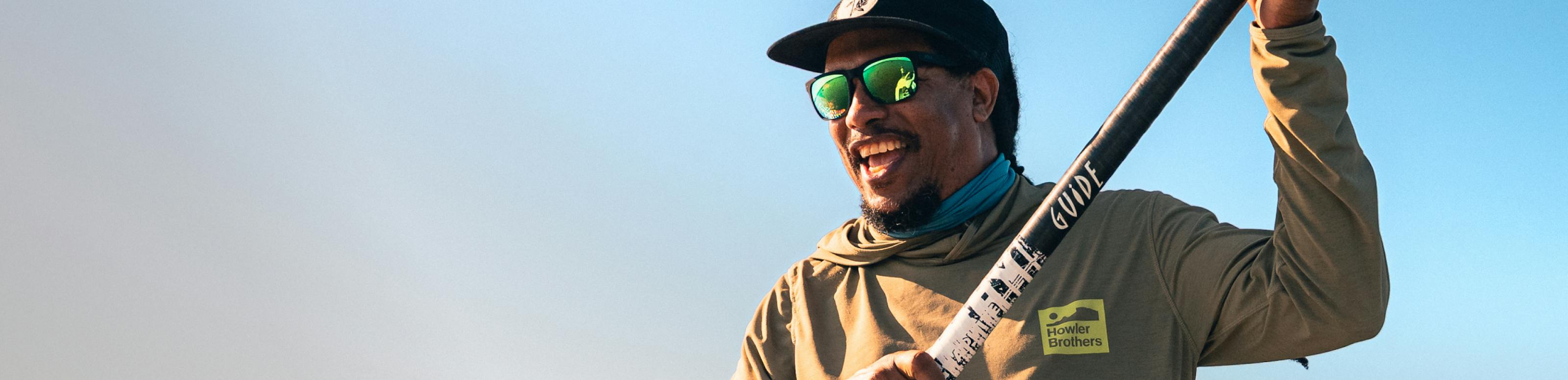 Man smiling wearing green mirror sunglasses