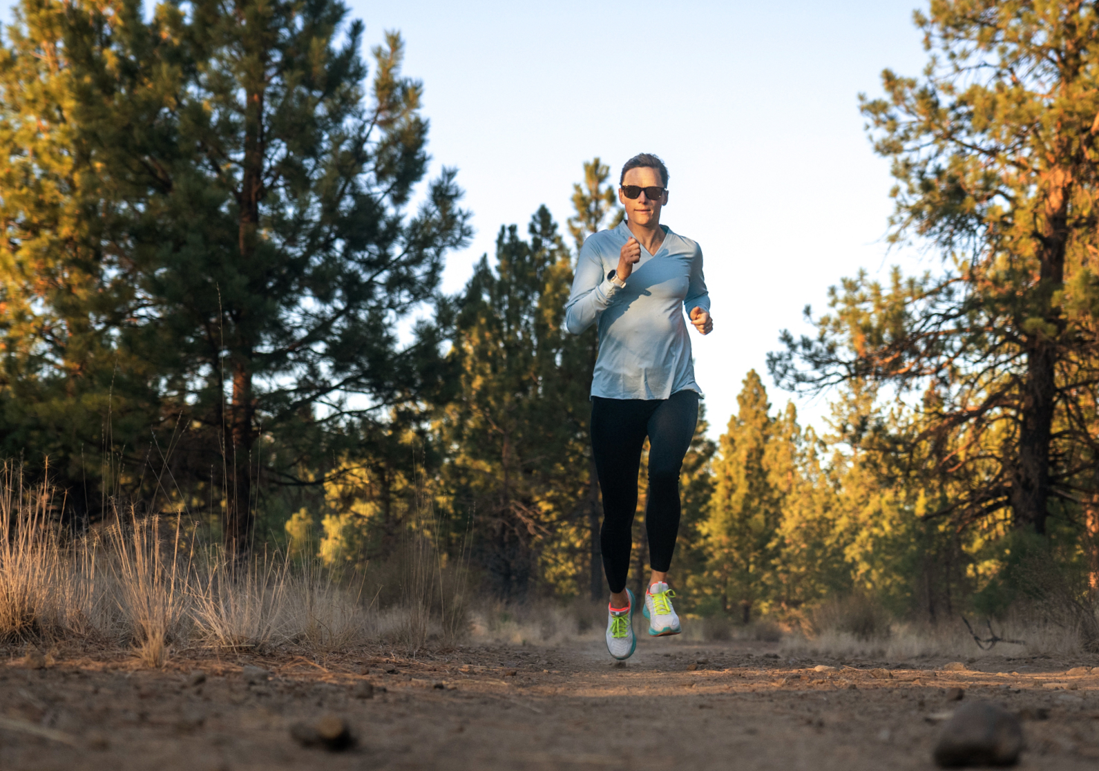 Woman trail running wearing Zilker sunglasses