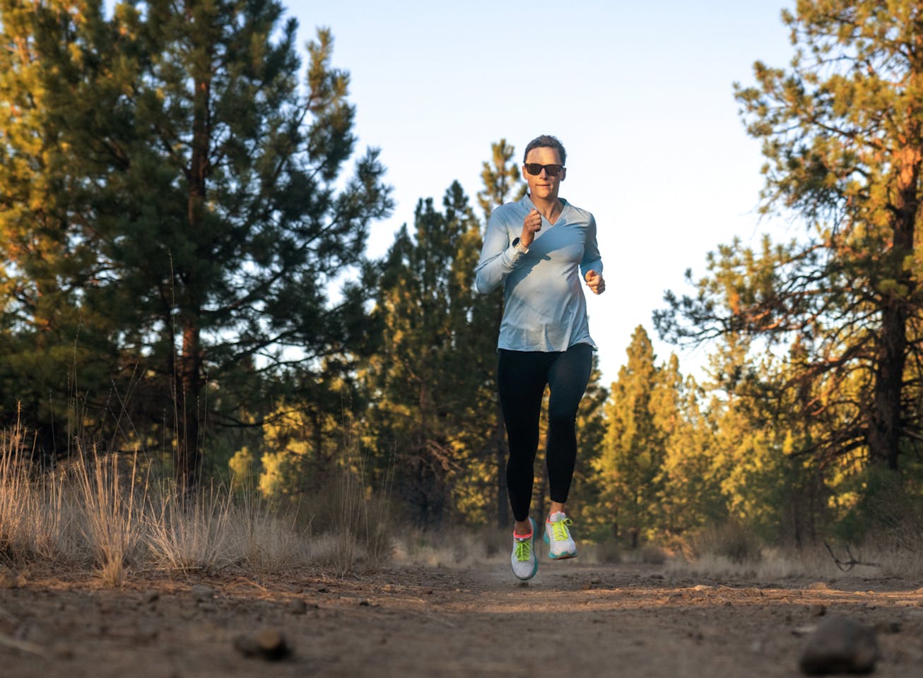 Woman trail running wearing Zilker sunglasses