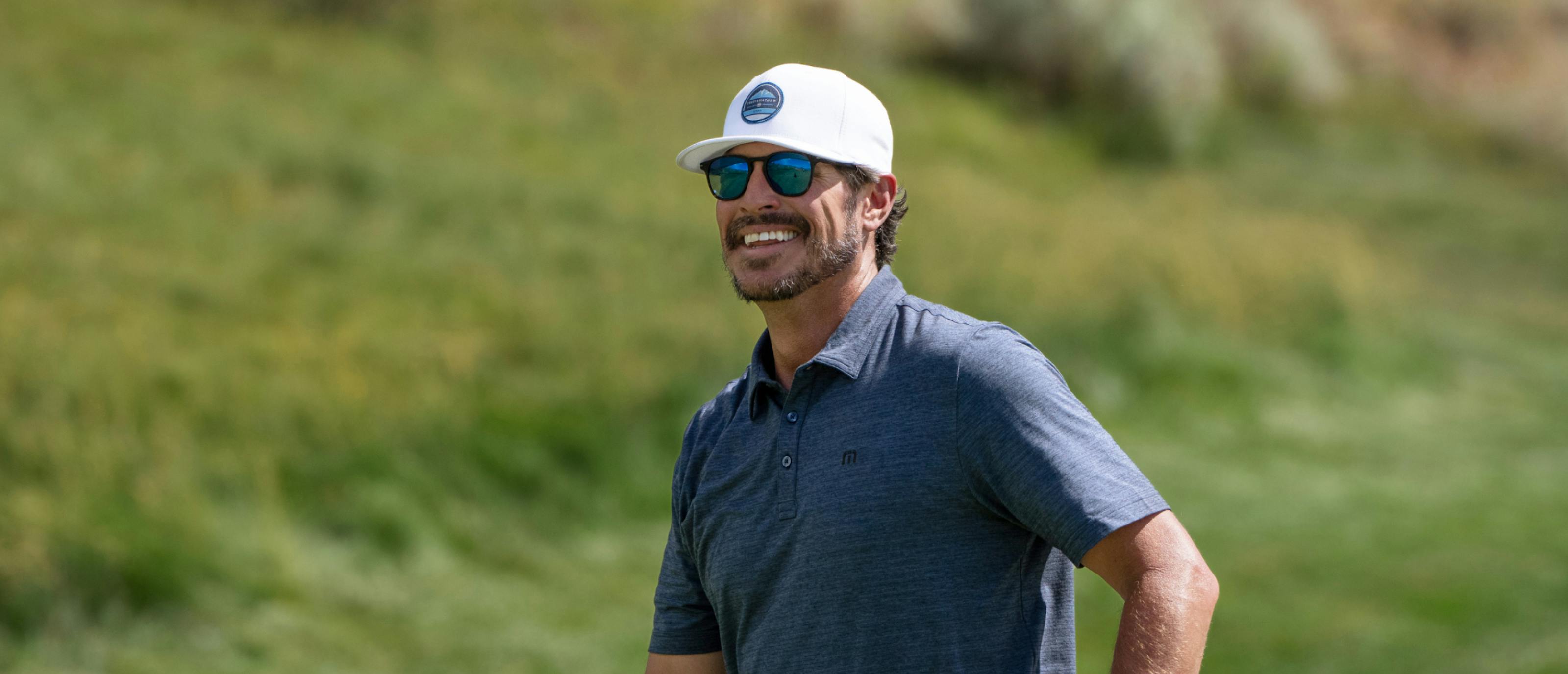 Man smiling on golf course wearing Hunter Sunglasses