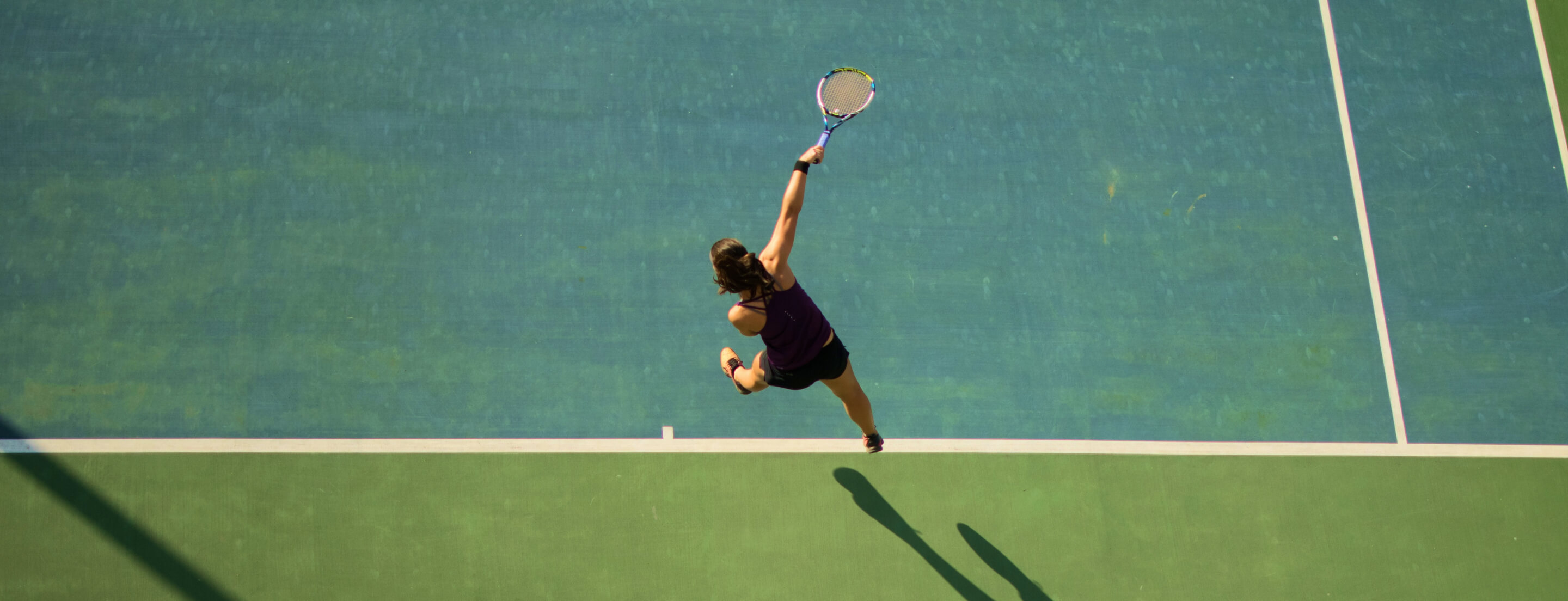 Woman doing overhand tennis shot