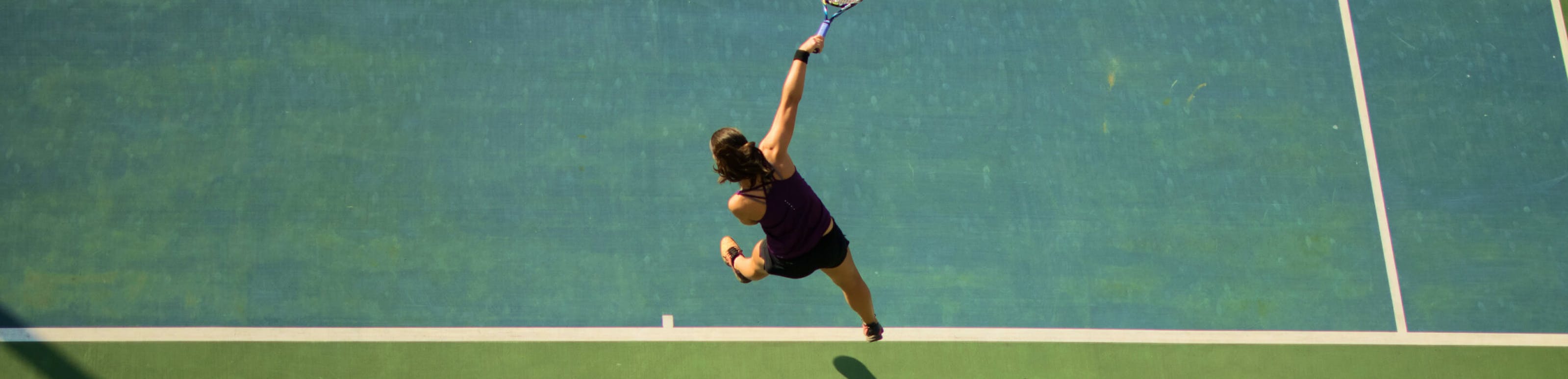 Woman doing overhand tennis shot
