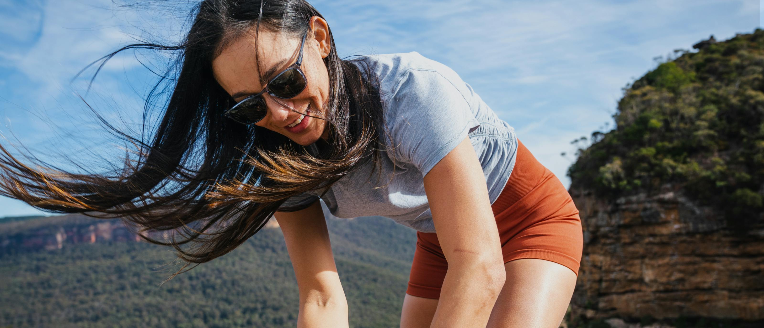 Woman outdoors smiling in Rory sunglasses