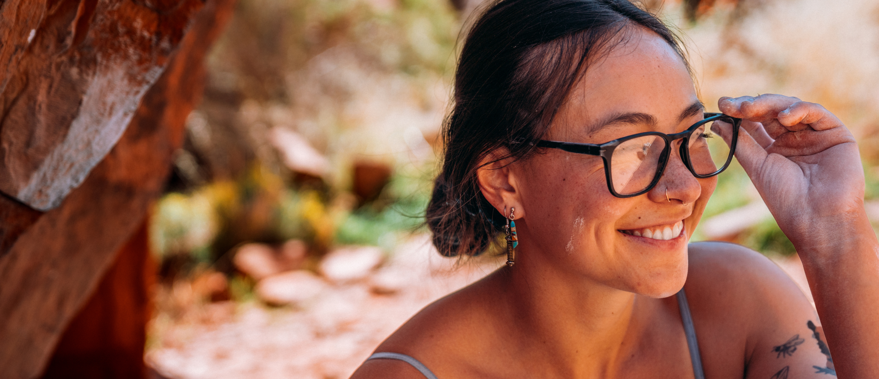 Woman smiling wearing square, black Hunter eyeglasses