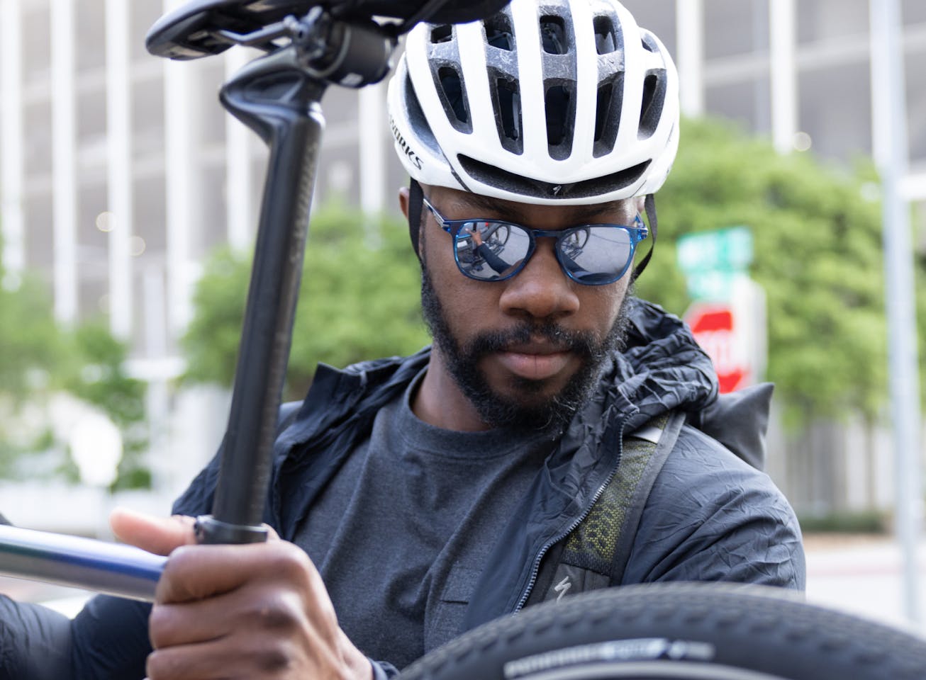 Man picking up bike wearing Hunter sunglasses