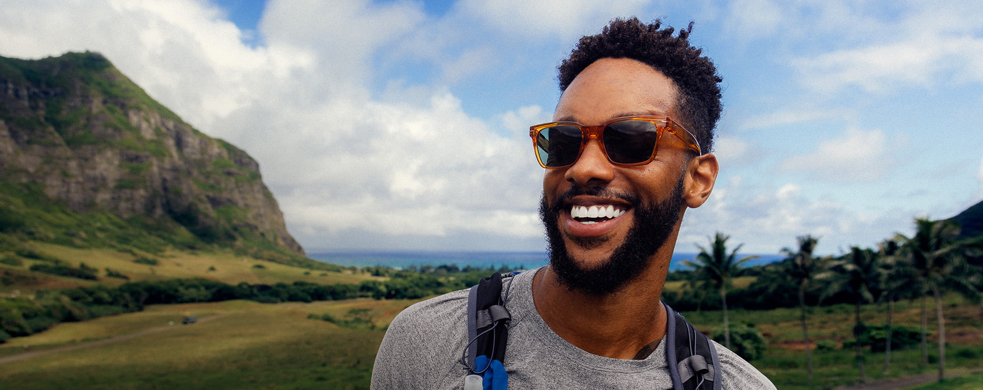 Man smiling outside wearing ROKA sunglasses