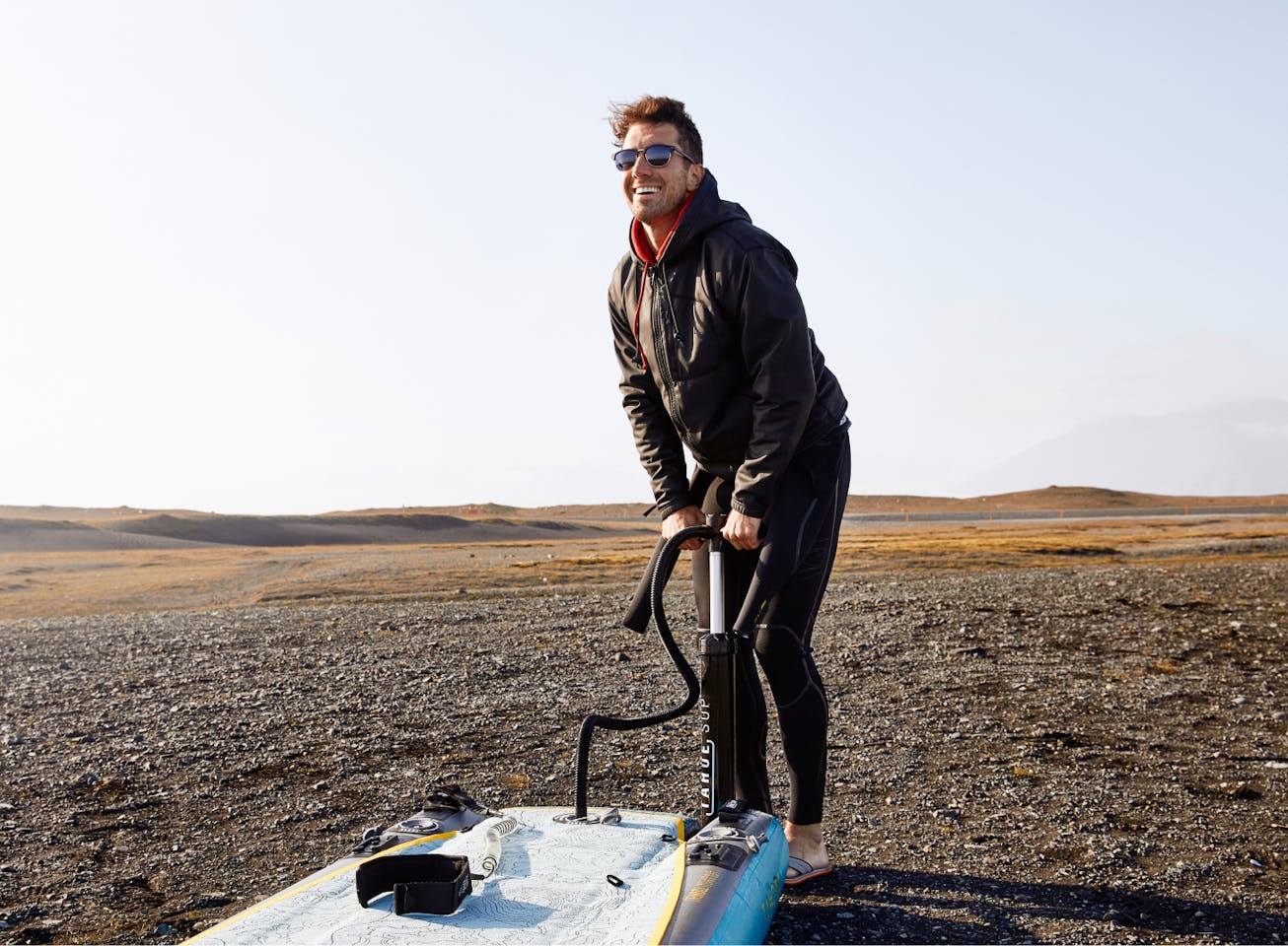 Man inflating boat wearing Cambridge sunglasses