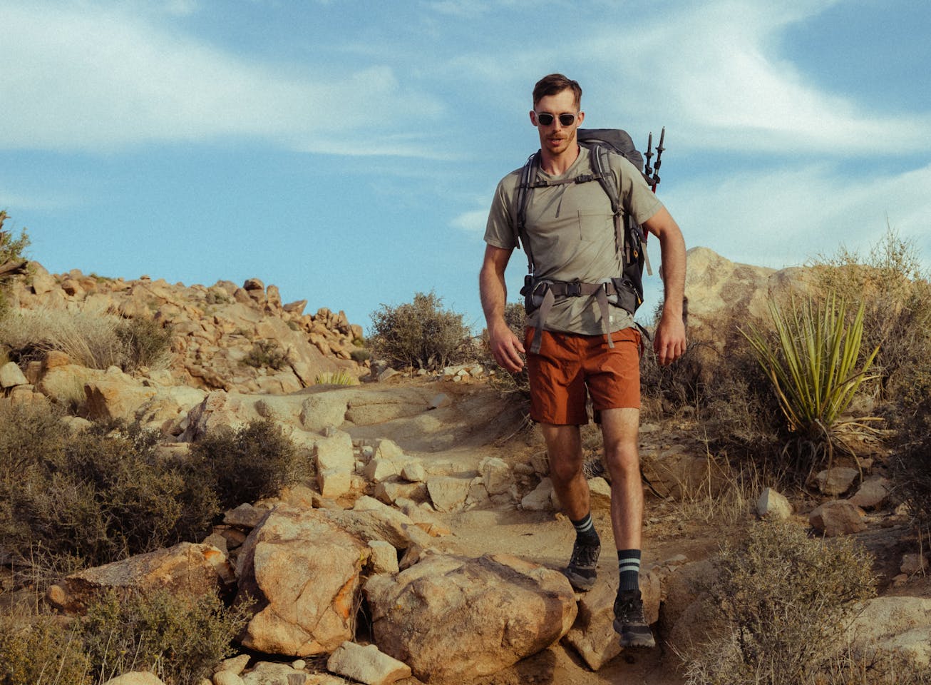 Rory hiking in desert wearing Rory sunglasses