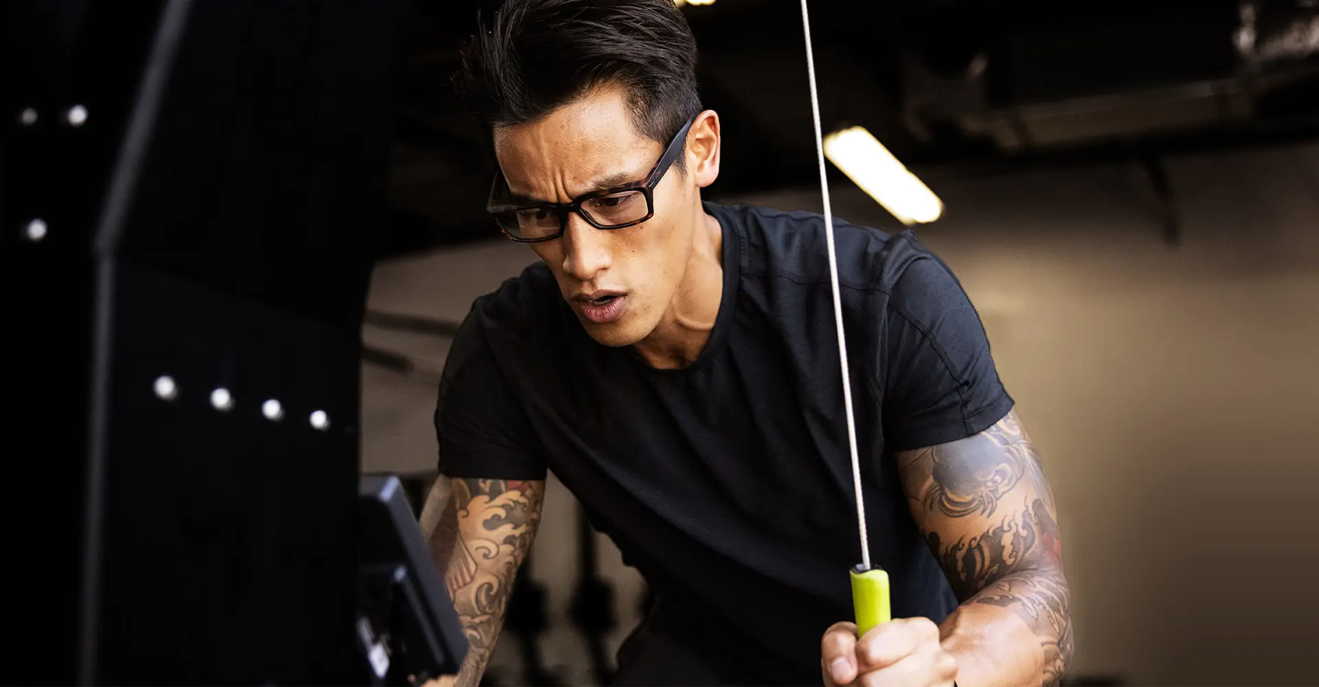 Man using upright rowing machine wearing Mayfield eyeglasses