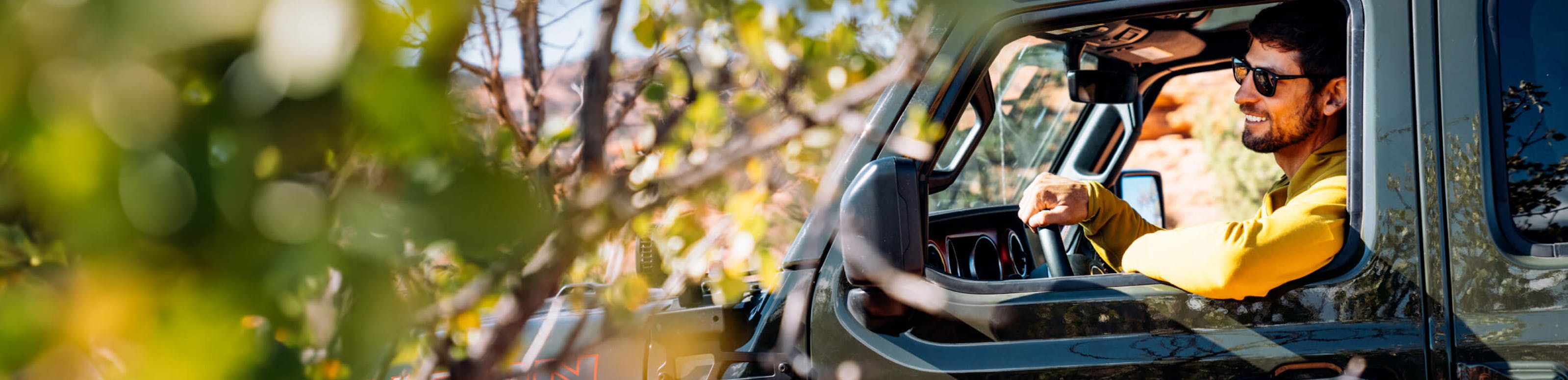 Man driving green car in ROKA sunglasses