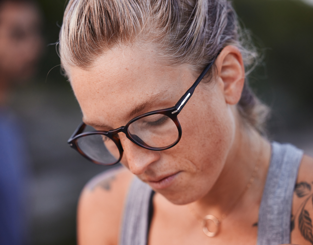 Woman in Oslo Eyeglasses - Tortoise Frames looking down