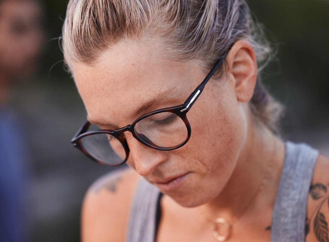 Woman in Oslo Eyeglasses - Tortoise Frames looking down